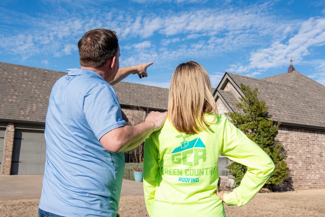 Rob and Elisha Moore looking at a roof
