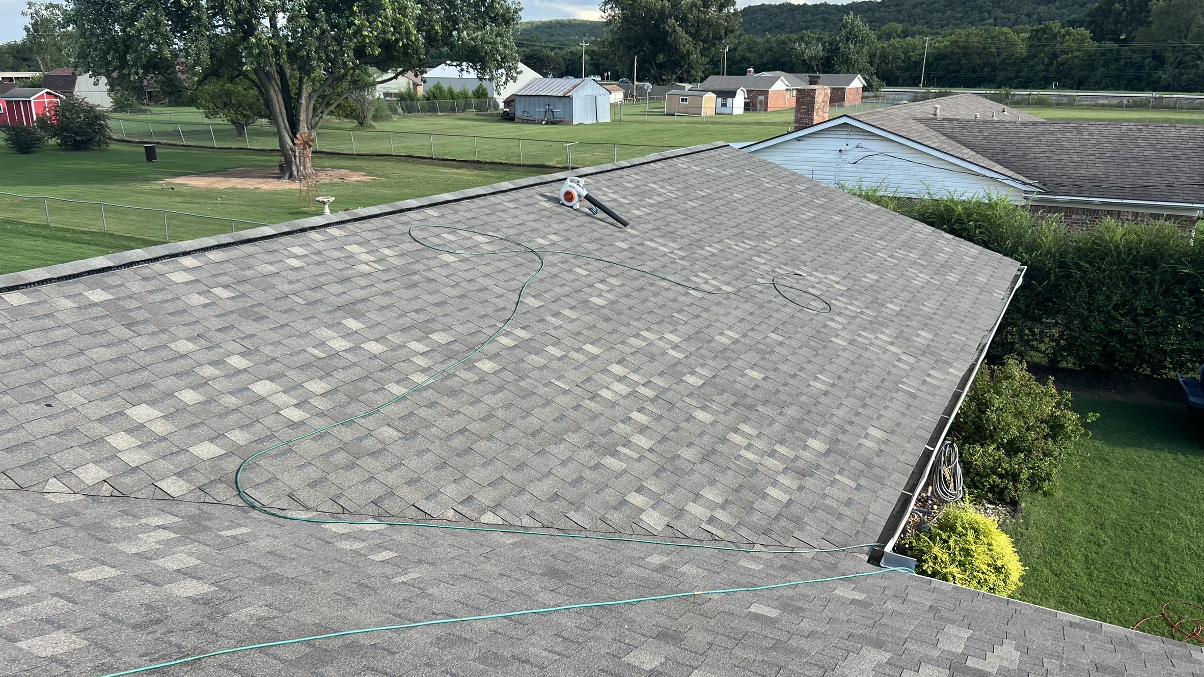 Completed wide shot — large gray shingle roof, clean install, great curb appeal closer