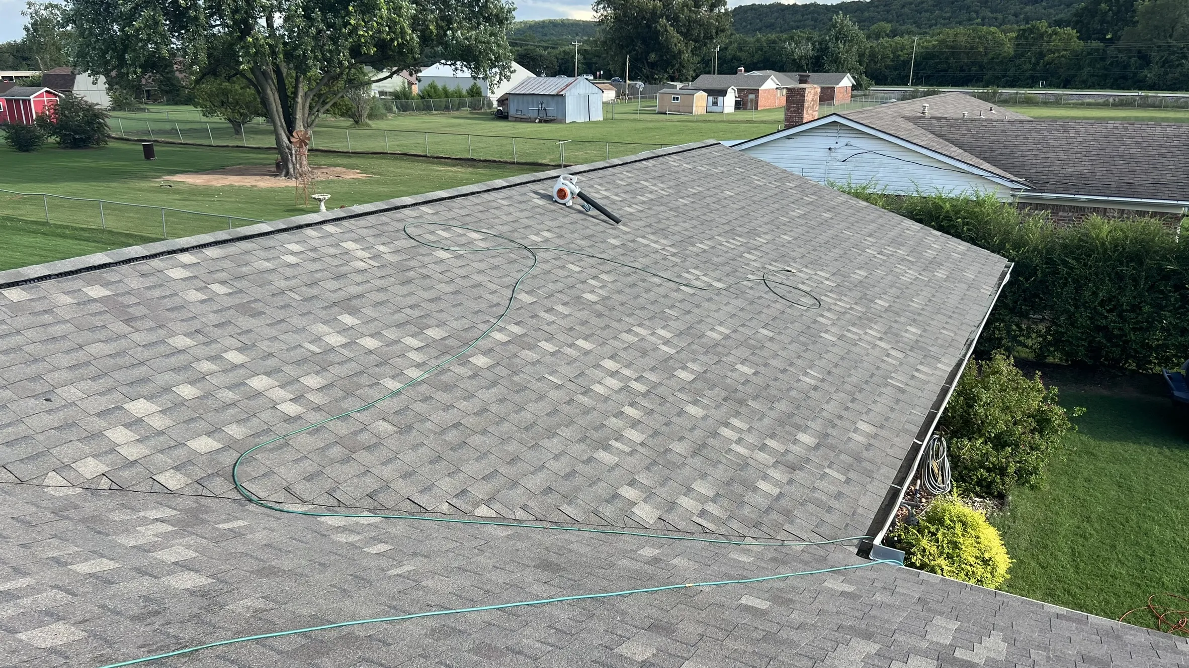Completed wide shot â€” large gray shingle roof, clean install, great curb appeal closer