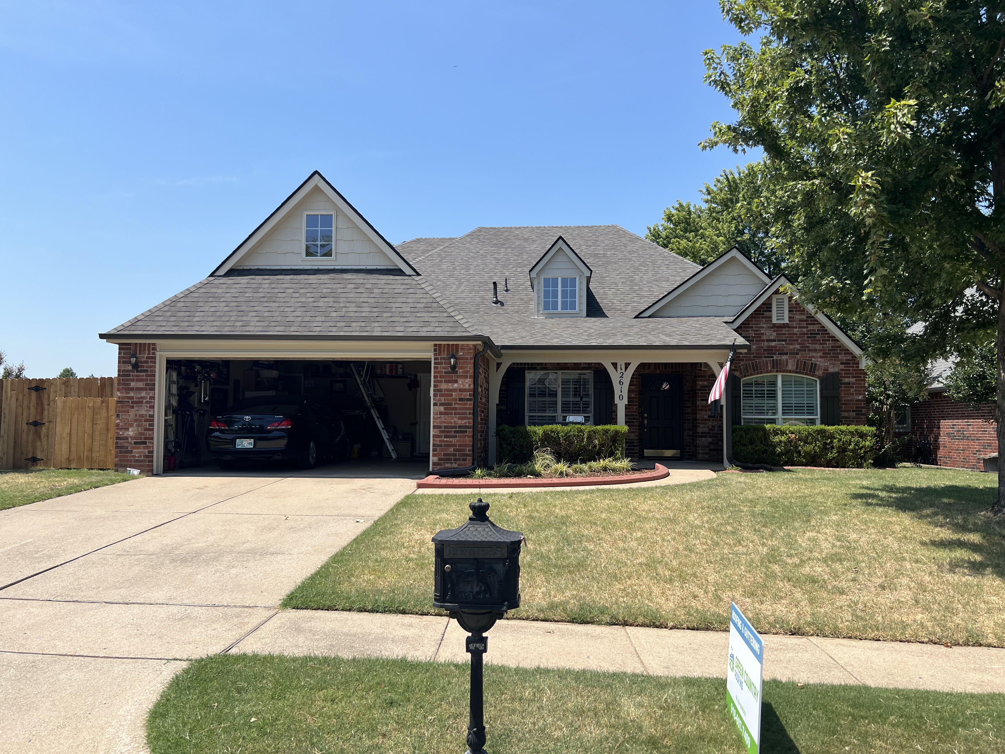 Finished roof with GCR yard sign — curb appeal closer