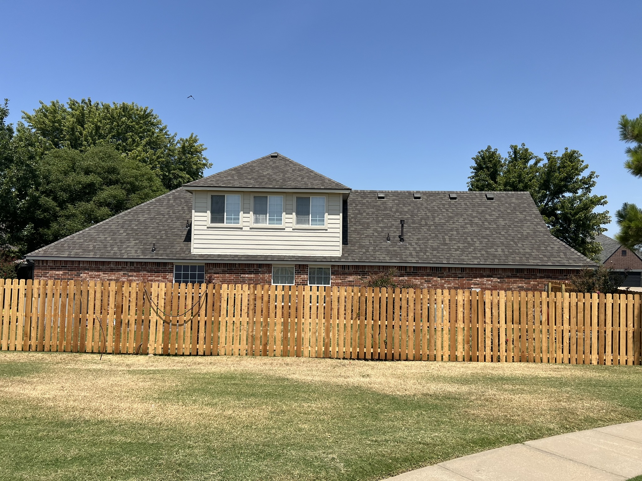 Finished GCR roof replacement and new fence on Tulsa home — properly handled insurance claim