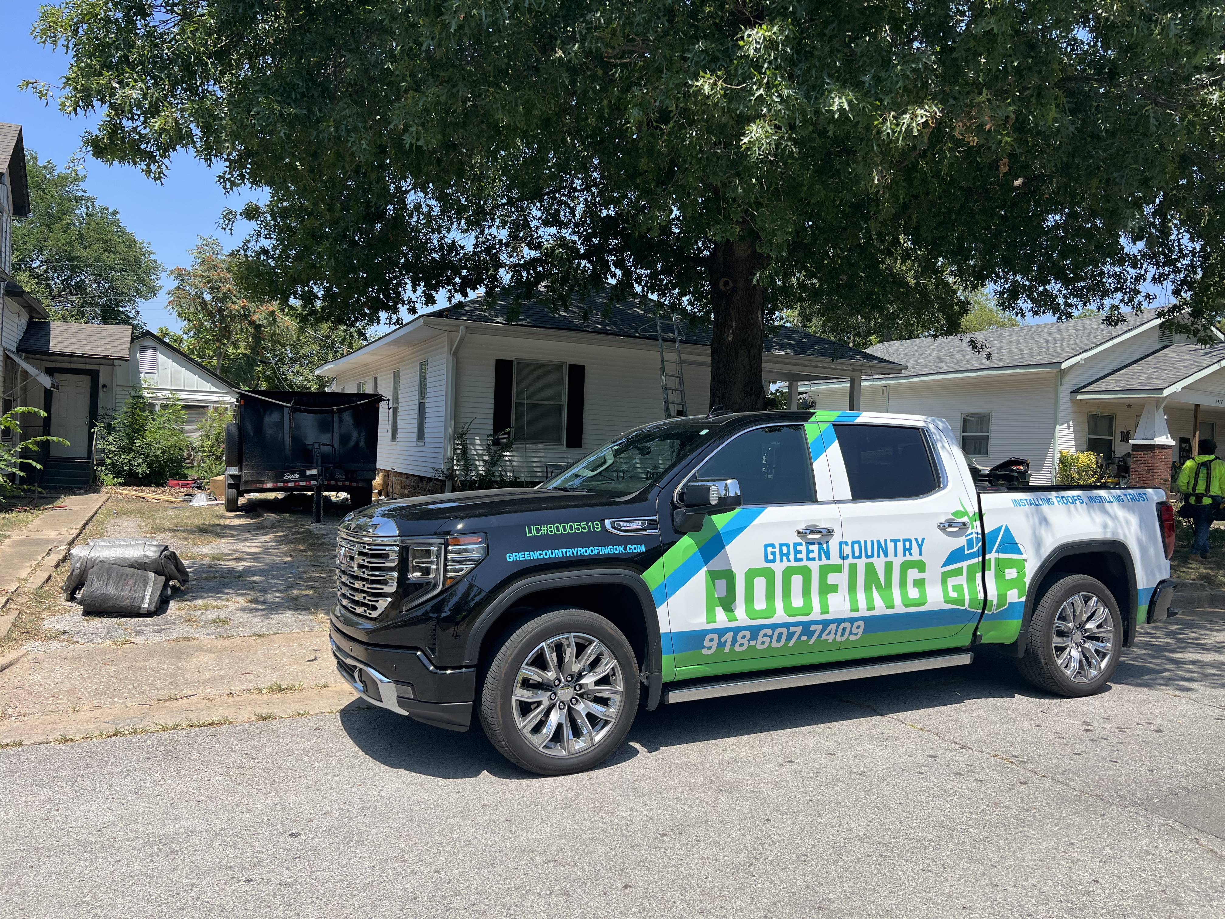GCR branded truck at job site, crew working in background — shows GCR showed up and handled it