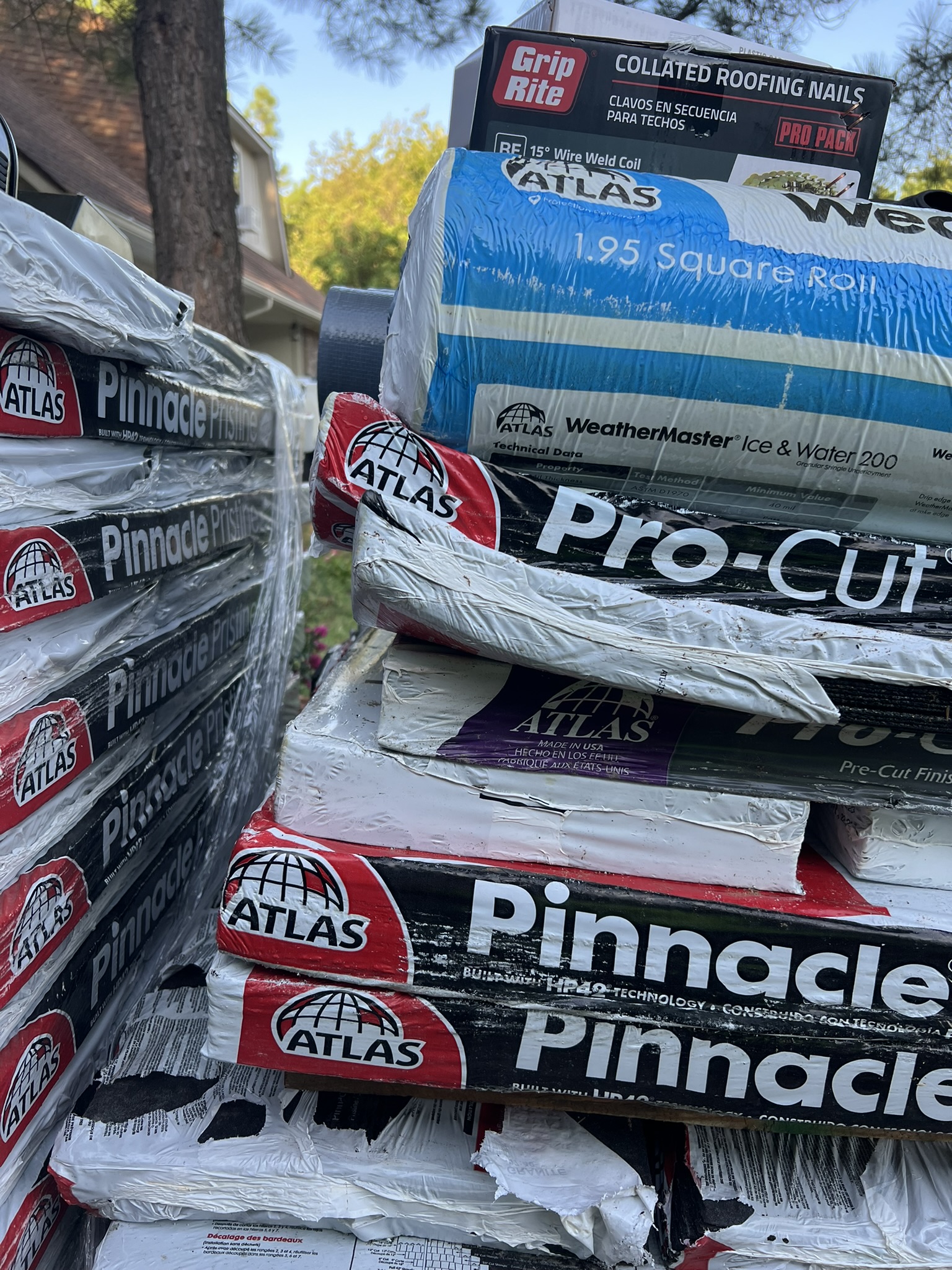 Atlas Pinnacle Pristine shingle bundles stacked with WeatherMaster ice and water shield on roof