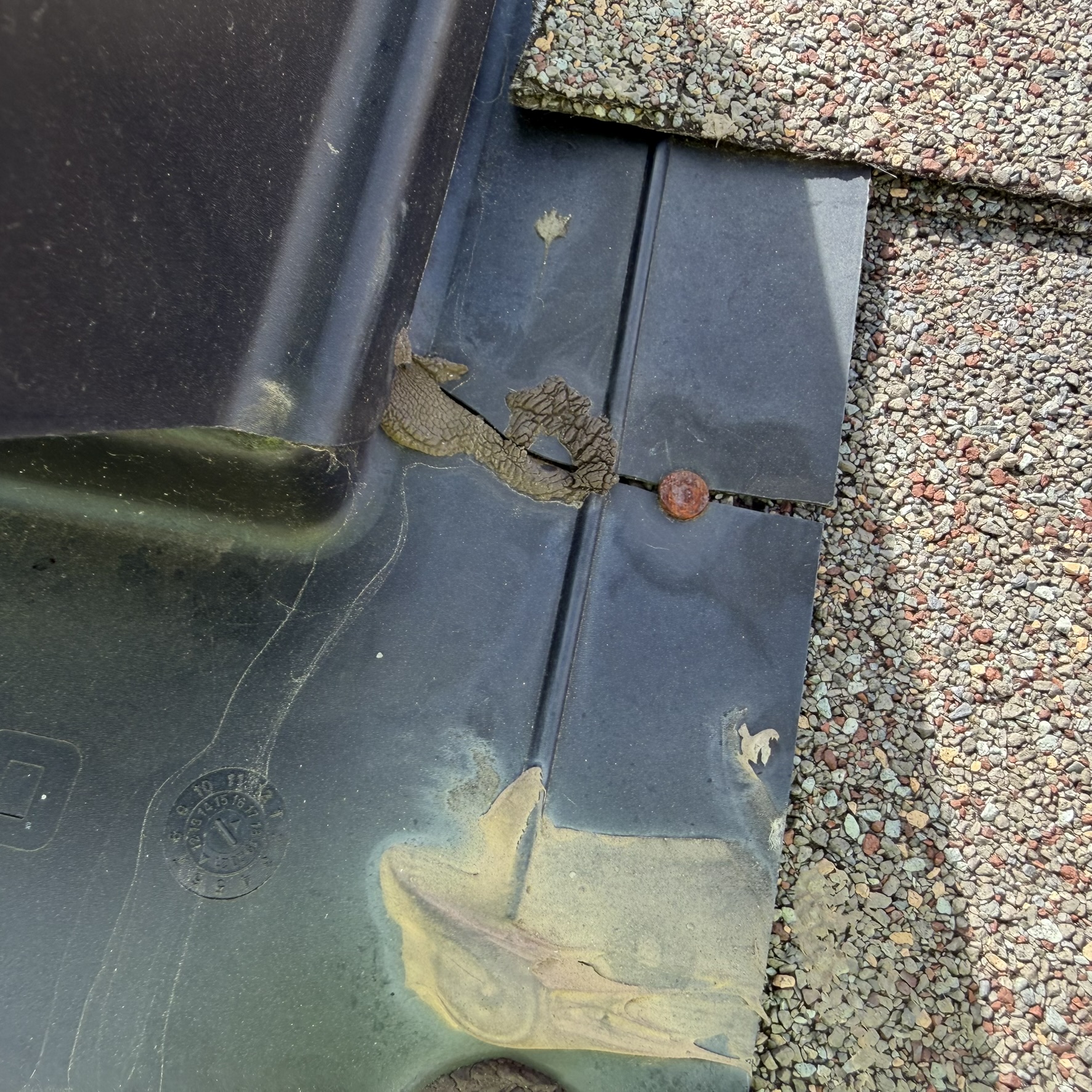 Old rusted chimney flashing reused on new roof install