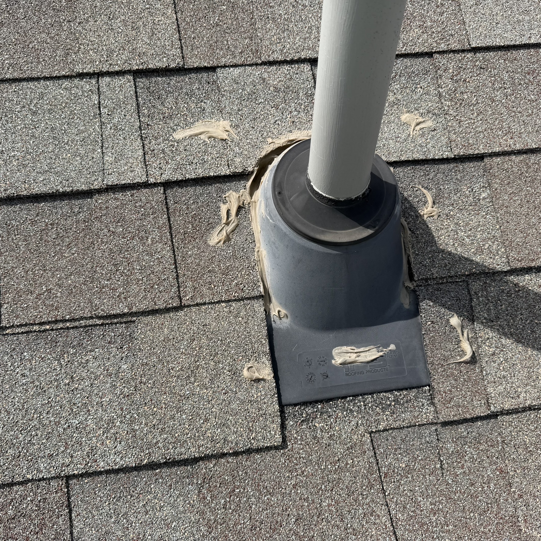 Failed pipe boot sealed with caulk blobs instead of proper replacement