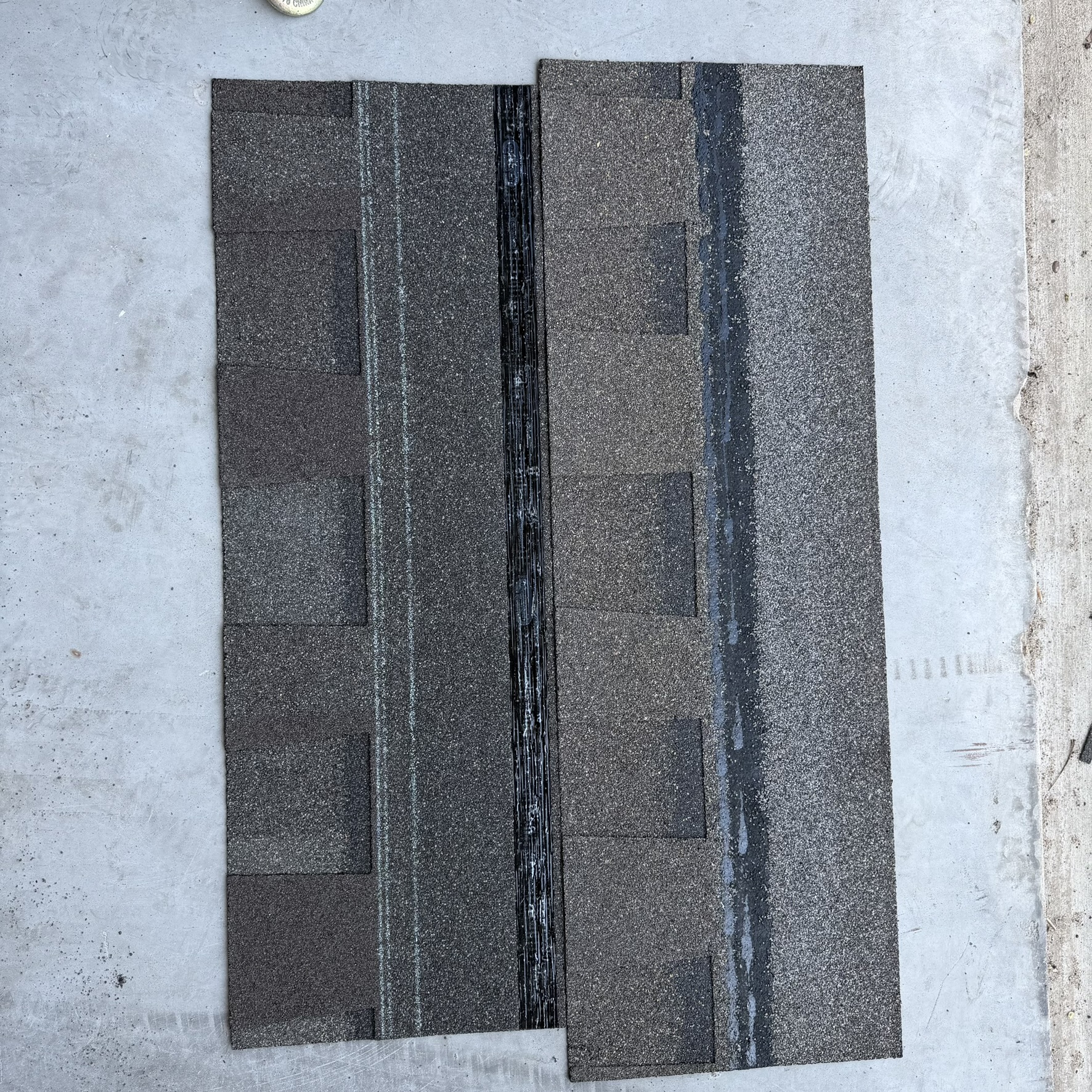Atlas and CertainTeed shingles laid side by side on concrete showing granule and sealant strip differences