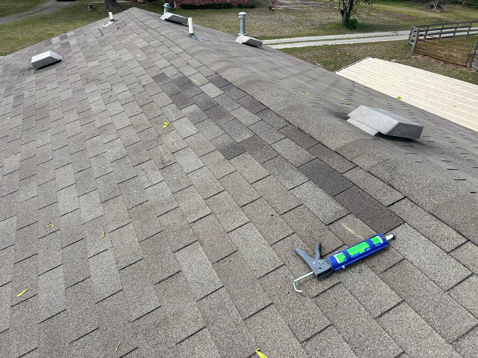 Blended shingle repair showing color variation between repaired section and original roof