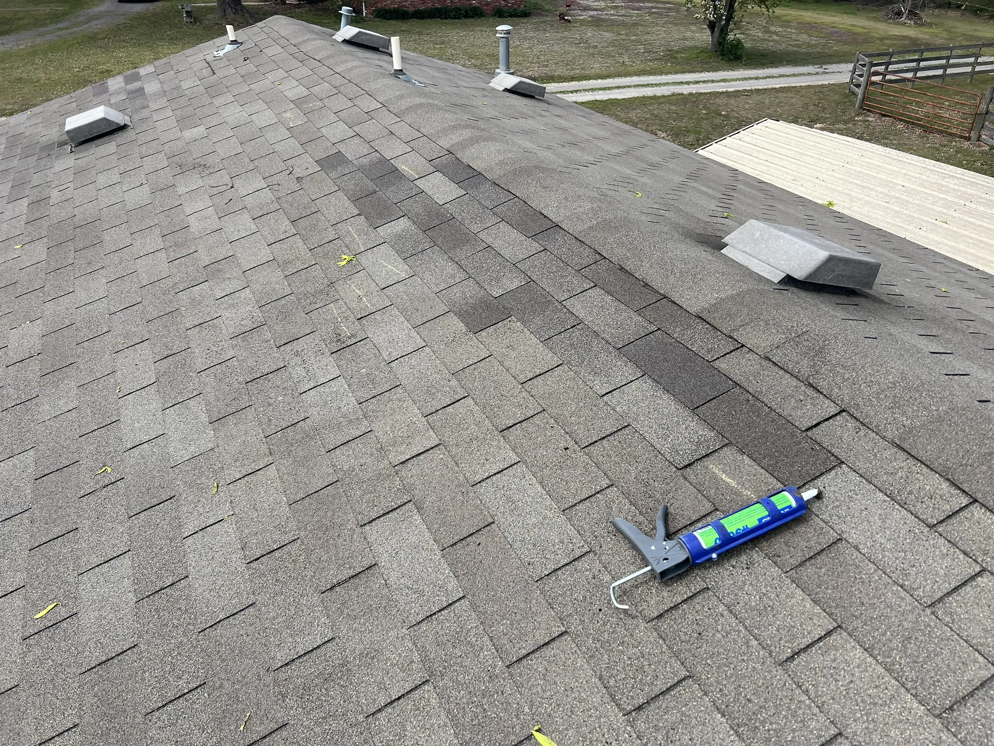 Blended shingle repair showing color variation between repaired section and original roof
