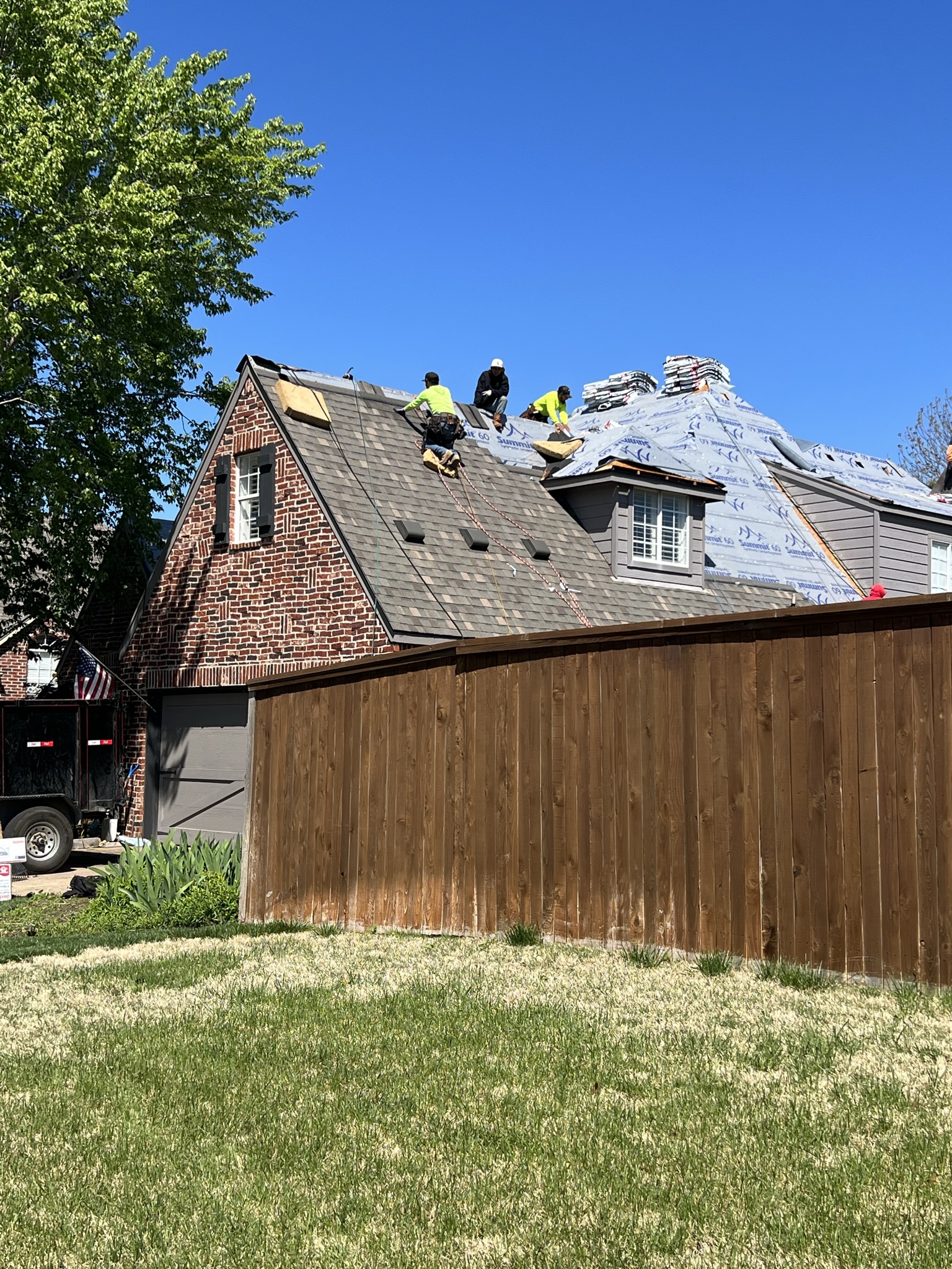 Crew working steep pitch — ties directly to pitch pricing section