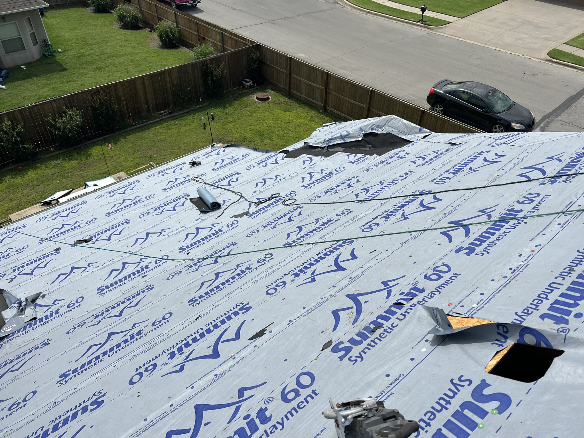 Atlas Summit 60 underlayment covering full roof deck with vent holes cut