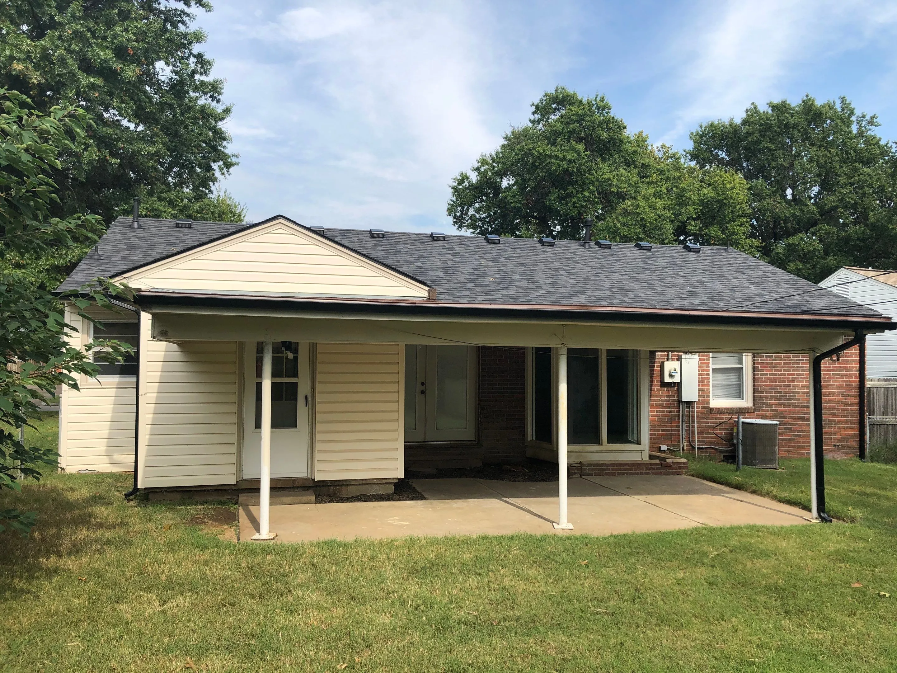 Ground level ranch home with row of box vents visible along roofline
