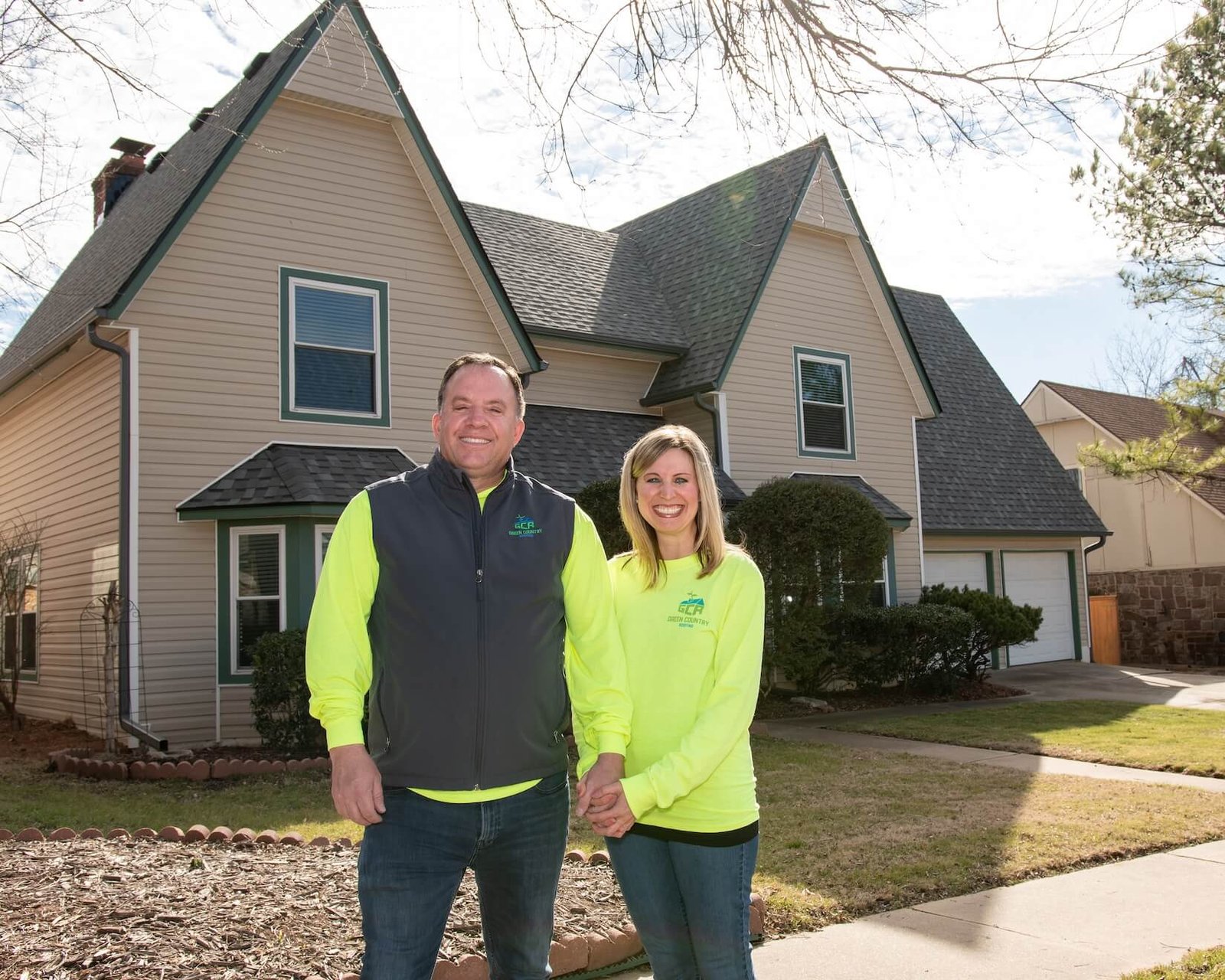 Rob and Elisha Moore in front of a Tulsa home