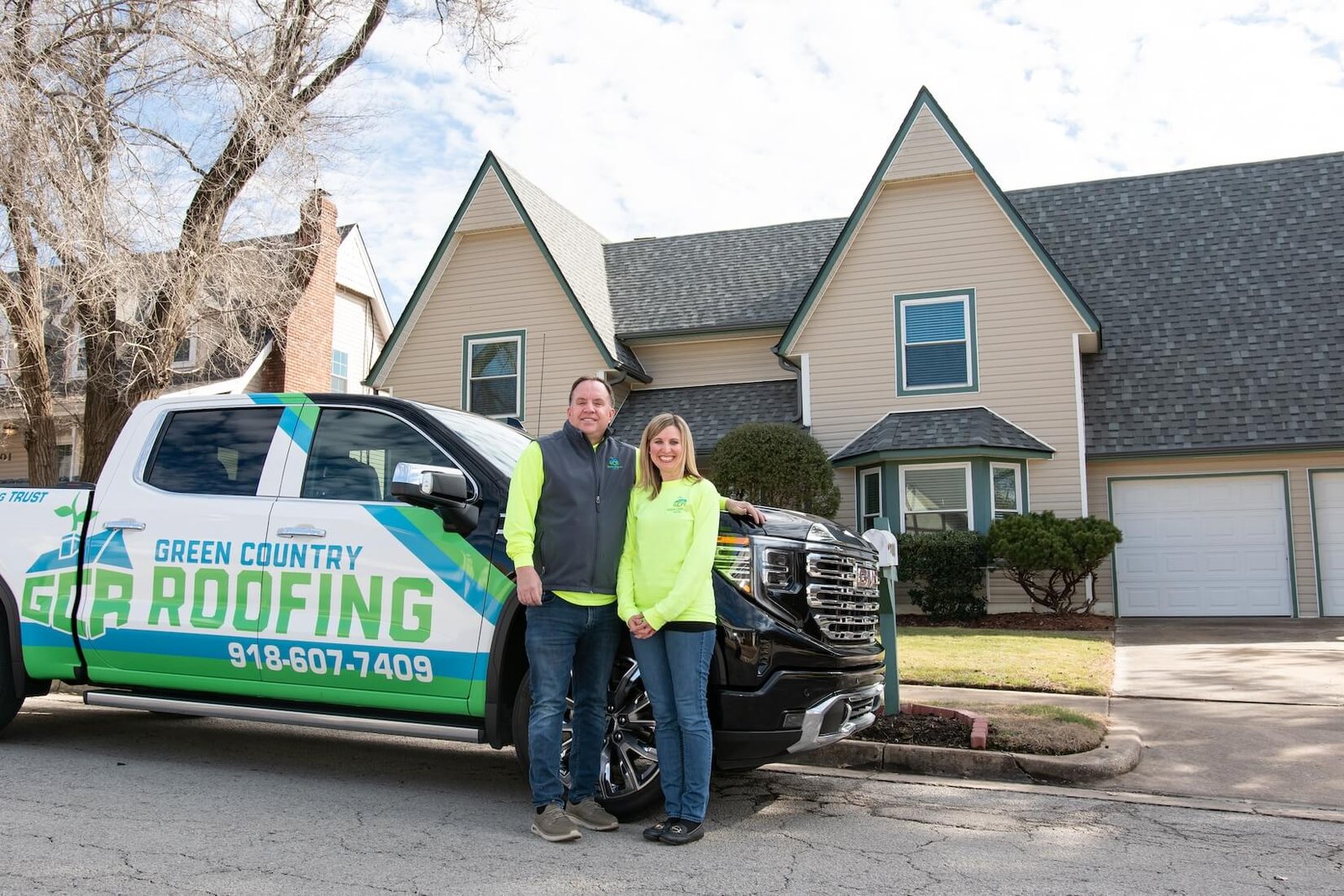 Rob and Elisha Moore with the Green Country Roofing truck in Tulsa
