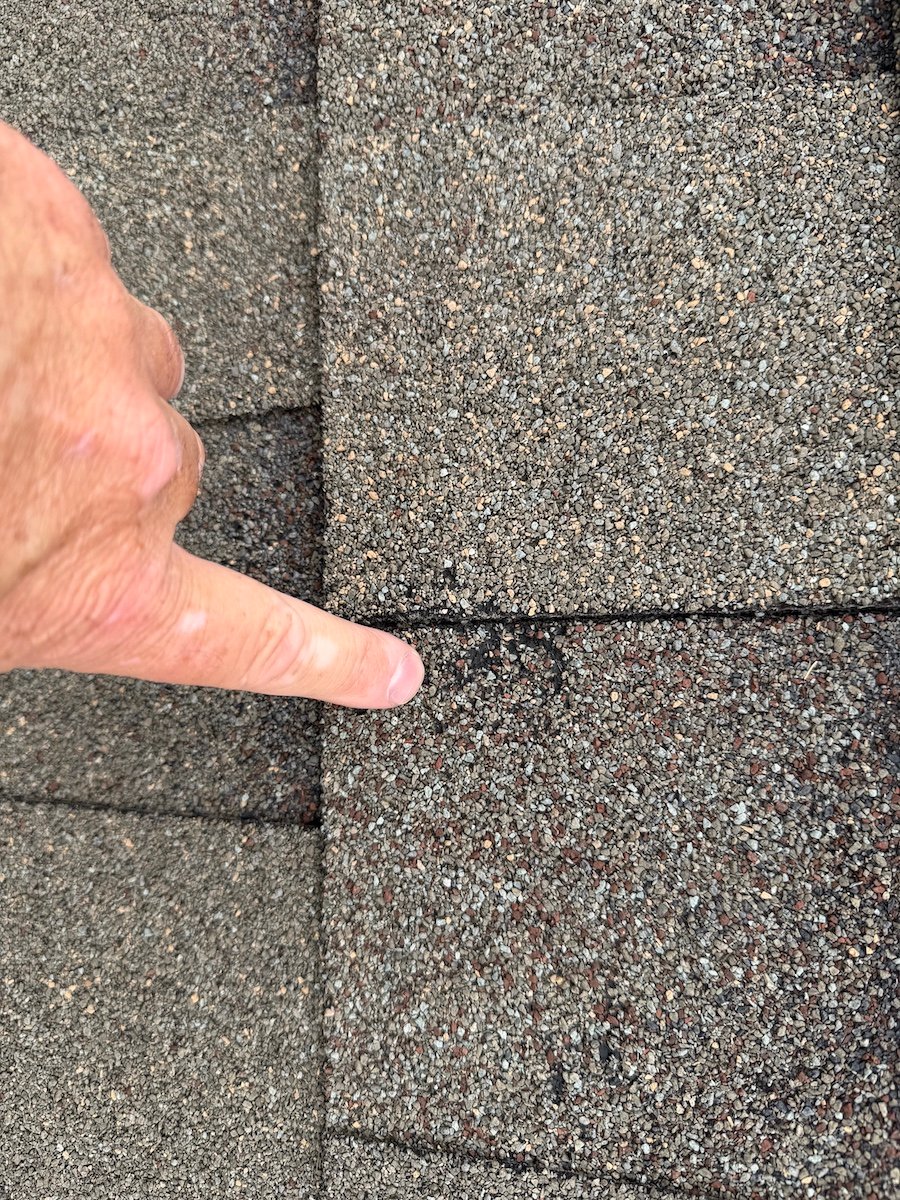 Tear-off day on a Tulsa roof replacement with crew, equipment and shingles staged